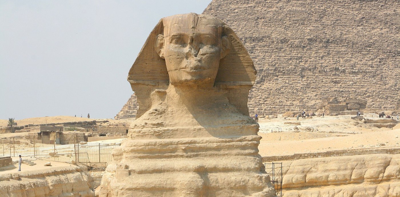 The weathered body of the Great Sphinx of Giza in its rock enclosure